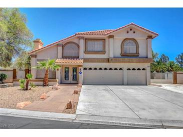 Charming two-story home featuring a three-car garage, tile roof, and well-maintained landscaping at 4542 Amber Canyon Ln, Las Vegas, NV 89129