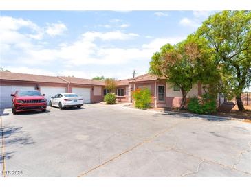 Charming single-story home featuring a spacious driveway and desert landscaping at 4656 E Desert Inn Rd, Las Vegas, NV 89121