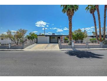 Charming single-story home with a well-manicured front yard and gated perimeter providing an inviting curb appeal at 4807 Sacks Dr, Las Vegas, NV 89122