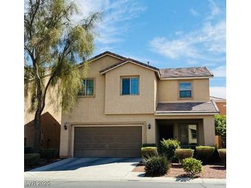 Charming two-story home with a neutral color palette, a two-car garage, and manicured front yard landscaping at 5484 Mercury Springs Dr, Las Vegas, NV 89122