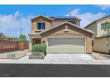 Two-story home featuring a two car garage, neutral color palette and solar panels at 6678 Crystal Run Ln, Las Vegas, NV 89122