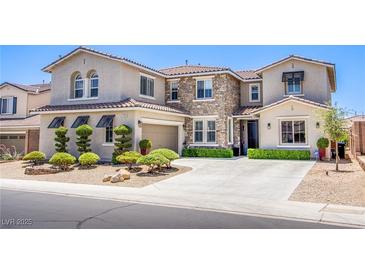 Beautiful two-story home with a stone facade and manicured front yard at 7445 Mezzanine View Ave, Las Vegas, NV 89178