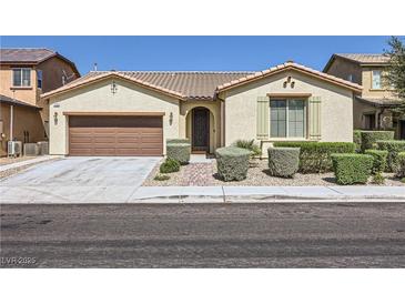 Charming single-story home featuring a well-manicured front yard and a two-car attached garage at 1792 Gentle Brook St, North Las Vegas, NV 89084
