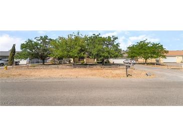 Charming single-story home with mature trees and a well-maintained front yard at 2230 Wagon Ave, Pahrump, NV 89048