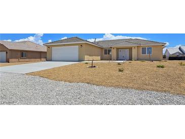 Charming single story home showcasing well kept front yard and two car garage at 3016 Mount Charleston Dr, Pahrump, NV 89048