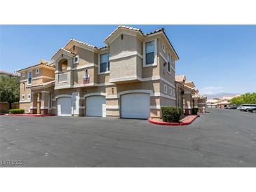 Inviting multi-Gathering home featuring well-maintained landscaping, attached garages, and ample parking spaces at 5855 Valley Dr # 2092, North Las Vegas, NV 89031