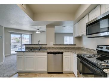 Modern kitchen with stainless steel appliances and granite countertops at 6800 E Lake Mead Blvd # 2072, Las Vegas, NV 89156