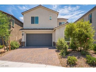 Charming two-story home with a two car garage and beautifully landscaped front yard with desert landscaping at 7124 Sayonara Vista St, North Las Vegas, NV 89084