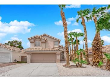 Charming two-story home featuring a tile roof, desert landscaping, and an attached two-car garage at 8379 Drop Camp St, Las Vegas, NV 89123