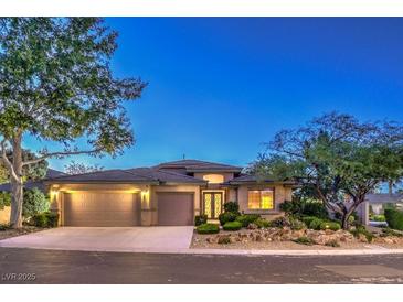Beautiful single-story home with mature landscaping, a three-car garage, and a neutral stucco exterior at 10300 Wellside Hill Ave, Las Vegas, NV 89145