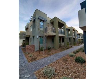 Modern two-story townhome featuring private balconies and contemporary architectural details at 11289 Vision Peak Ave # 103, Las Vegas, NV 89135