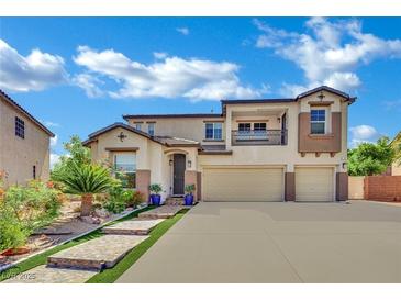 Charming two-story home with a three car garage, stone steps and green landscaping at 15 Imposing Knoll Ave, Henderson, NV 89002
