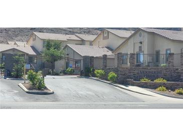 Gated community entrance featuring stone accents and manicured landscaping at 2050 N Los Feliz St # 170, Las Vegas, NV 89156
