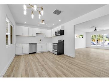 Bright kitchen features white cabinets, stainless steel appliances, and ample counter space at 2105 Berkley Ave, Las Vegas, NV 89101