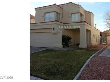 Charming two-story home with a well-maintained front lawn and attached two-car garage, great curb appeal at 309 Clifton Heights Dr, Las Vegas, NV 89145