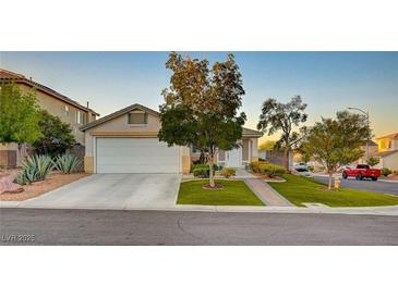 Charming single-story home featuring a well-manicured lawn and inviting two-car garage with mature landscaping at 528 Lavina Ct, Las Vegas, NV 89123
