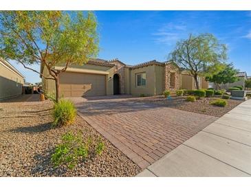 Charming single-story home boasts a brick driveway, desert landscaping, and a two-car garage at 5953 Yellow Ridge Ave, Las Vegas, NV 89131