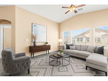 Bright living room featuring a ceiling fan, neutral paint, lots of natural light and modern furnishings at 9338 Square Dance Pl # 101, Las Vegas, NV 89178