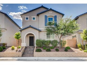Charming two-story home with a landscaped yard, appealing facade, and covered entry at 10556 Sariah Skye Ave, Las Vegas, NV 89166
