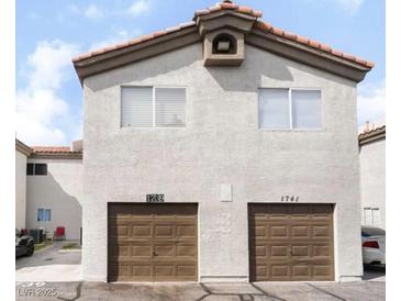 Charming two-story townhome featuring private garages and desert landscaping at 1739 N Lamont St, Las Vegas, NV 89115