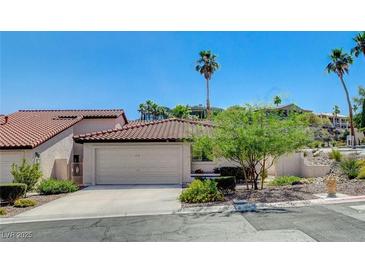 Charming single-story home featuring a red tile roof, well-manicured landscaping, and a two-car garage at 439 Columbia Ct, Boulder City, NV 89005