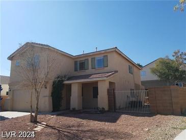 Two-story home featuring desert landscaping, a two-car garage, and a covered porch at 7517 Apple Cider St, Las Vegas, NV 89131