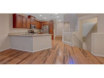 Beautiful kitchen with granite counters, stainless appliances, and an island with bar seating at 7856 Carysford Ave, Las Vegas, NV 89178