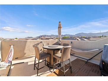 Enjoy the outdoor living space with mountain views on this rooftop patio with dining and lounging furniture at 10733 Red Badge Ave, Las Vegas, NV 89166