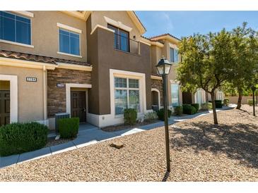 Charming townhouse with stone accents, manicured landscaping, and warm neutral colors at 2786 Fountain Ridge Ln, Henderson, NV 89074