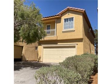 Two-story home featuring a two-car garage and a charming balcony at 3508 Harbor Tides St, Las Vegas, NV 89147