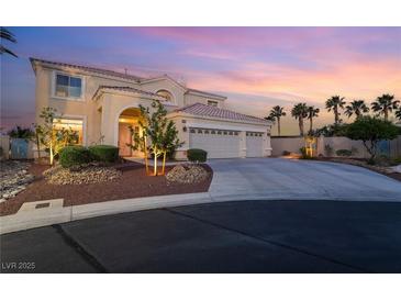 Charming two-story home featuring a well-manicured lawn, three-car garage, and inviting front entrance at 352 Angels Trace Ct, Las Vegas, NV 89148