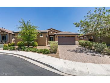 Beautiful single-story home featuring a brick driveway, manicured landscaping, and a welcoming entrance at 368 Calabria Beach St, Henderson, NV 89015
