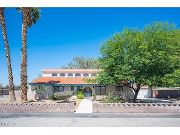 Charming exterior view featuring a red tile roof, mature trees, and inviting curb appeal at 3790 W Moberly Ave, Las Vegas, NV 89139