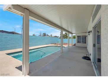 Inviting covered patio with a pool and spa, ideal for outdoor relaxation and entertainment at 519 Landra Ln, Henderson, NV 89015