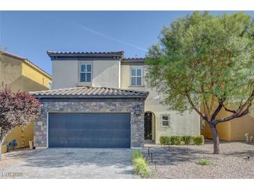 Charming two-story home featuring a stone accented facade and a well-maintained front yard at 599 Wounded Star Ave, Las Vegas, NV 89178
