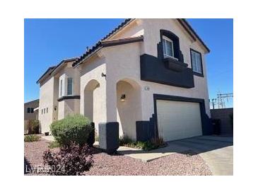 Charming two-story home with attached garage and well-maintained front yard at 648 Jumbled Sage Ct, Henderson, NV 89015