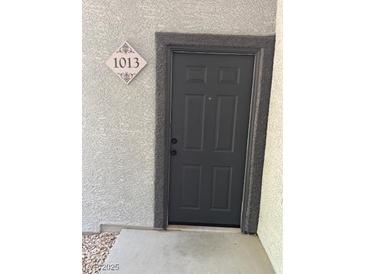 Apartment front door with visible unit number and dark gray door at 6955 N Durango Dr # 1013, Las Vegas, NV 89149