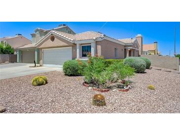 Charming home featuring desert landscaping, a two-car garage, and a welcoming front entrance at 7019 Shadow Crest Dr, Las Vegas, NV 89119