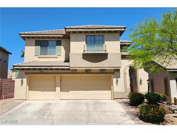 Tan two-story home featuring a three-car garage and desert landscaping under a clear blue sky at 9052 Pine Mission Ave, Las Vegas, NV 89143