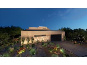 Stunning modern home with desert landscaping and a two-car garage at twilight at 120 Still Shores St, Henderson, NV 89011