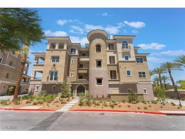 Stunning condo building showcasing modern architecture, a meticulously landscaped entrance, and picturesque palm trees at 128 Los Cabos Dr # 202, Las Vegas, NV 89144