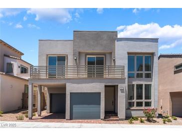 Modern two-story home features a balcony, two-car garage and contemporary architectural design at 1801 Flycatch St, Las Vegas, NV 89138