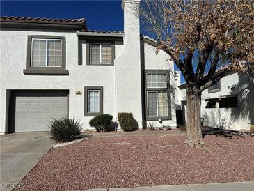Charming two-story home featuring a well-maintained lawn and attached garage at 213 Luninborg St, Henderson, NV 89074