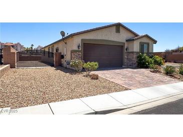 Charming single-story home featuring a two-car garage, desert landscaping, and gated front entry for added privacy at 2772 Brinkley Manor St, Laughlin, NV 89029