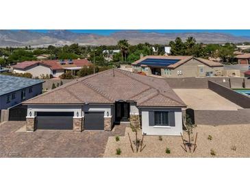 Charming single-story home with a paver driveway, two-car garage, and desert landscaping at 5851 Slate Rock Ct, Las Vegas, NV 89149