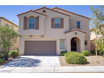Two-story stucco home featuring a two-car garage, desert landscaping, and covered front entry at 7263 Pepperbox Ave, Las Vegas, NV 89179