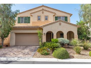 Charming two-story home with a covered front porch and a well-manicured lawn at 7854 Brianna Cheerful Ave, Las Vegas, NV 89178