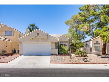 Charming single-story home with a well-manicured lawn and attached two-car garage at 8324 Tide Pool Dr, Las Vegas, NV 89128