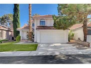 Charming two-story home with a red tile roof, manicured lawn, and a spacious two-car garage at 8809 Beach Front Dr, Las Vegas, NV 89117