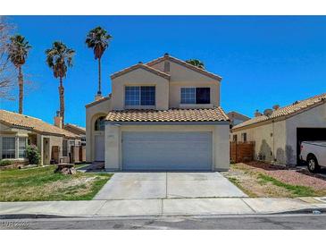 Inviting two-story home featuring a tile roof, desert landscaping, and attached two-car garage at 901 Carnival Ave, Las Vegas, NV 89123
